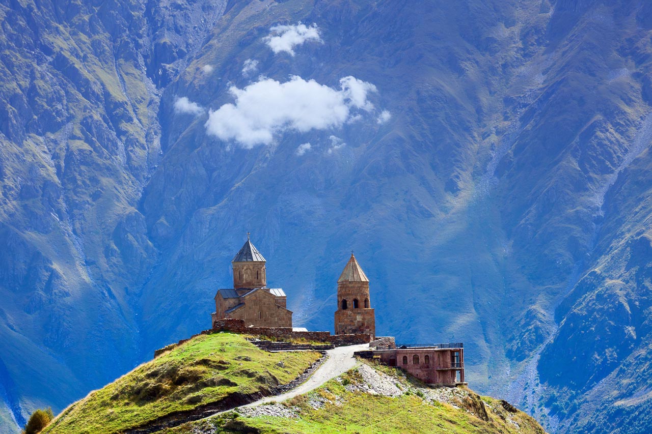 Gergeti christian church near Kazbegi, Stepancminda village in Georgia, Caucasus.